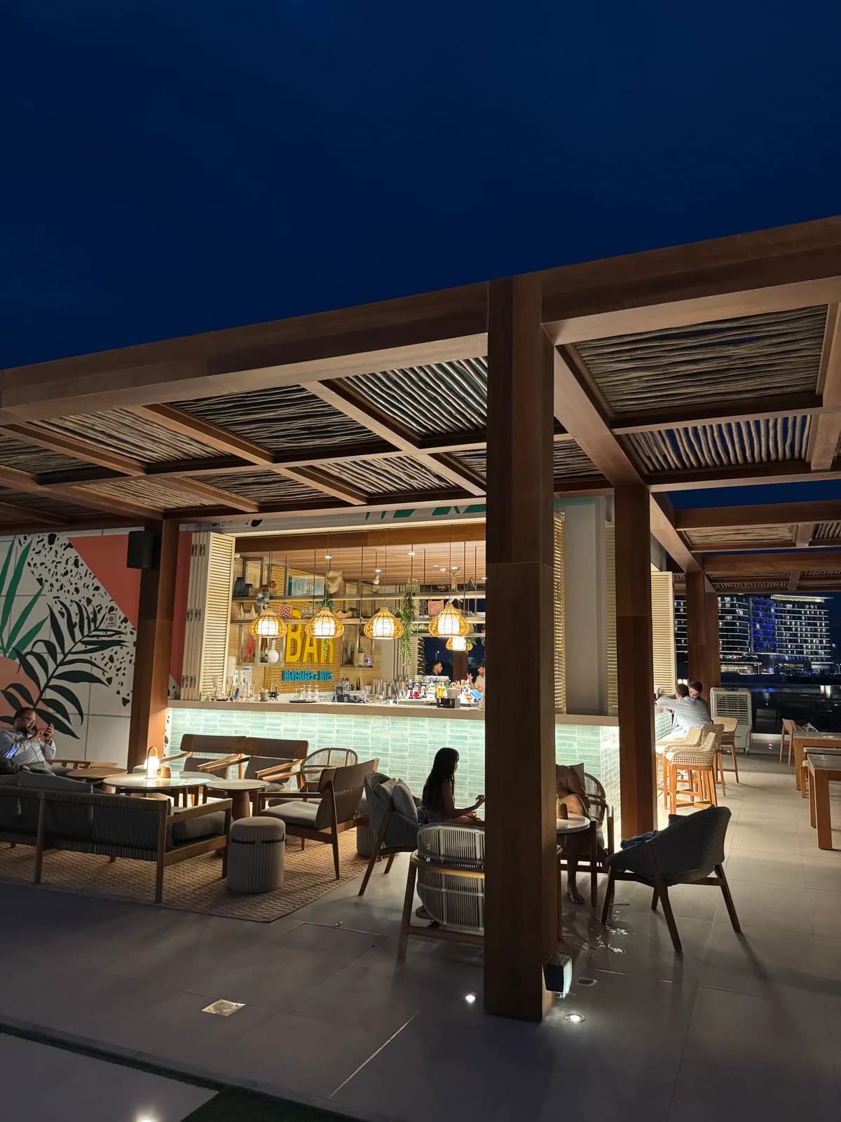 The illuminated poolside bar area at Rove after dark.