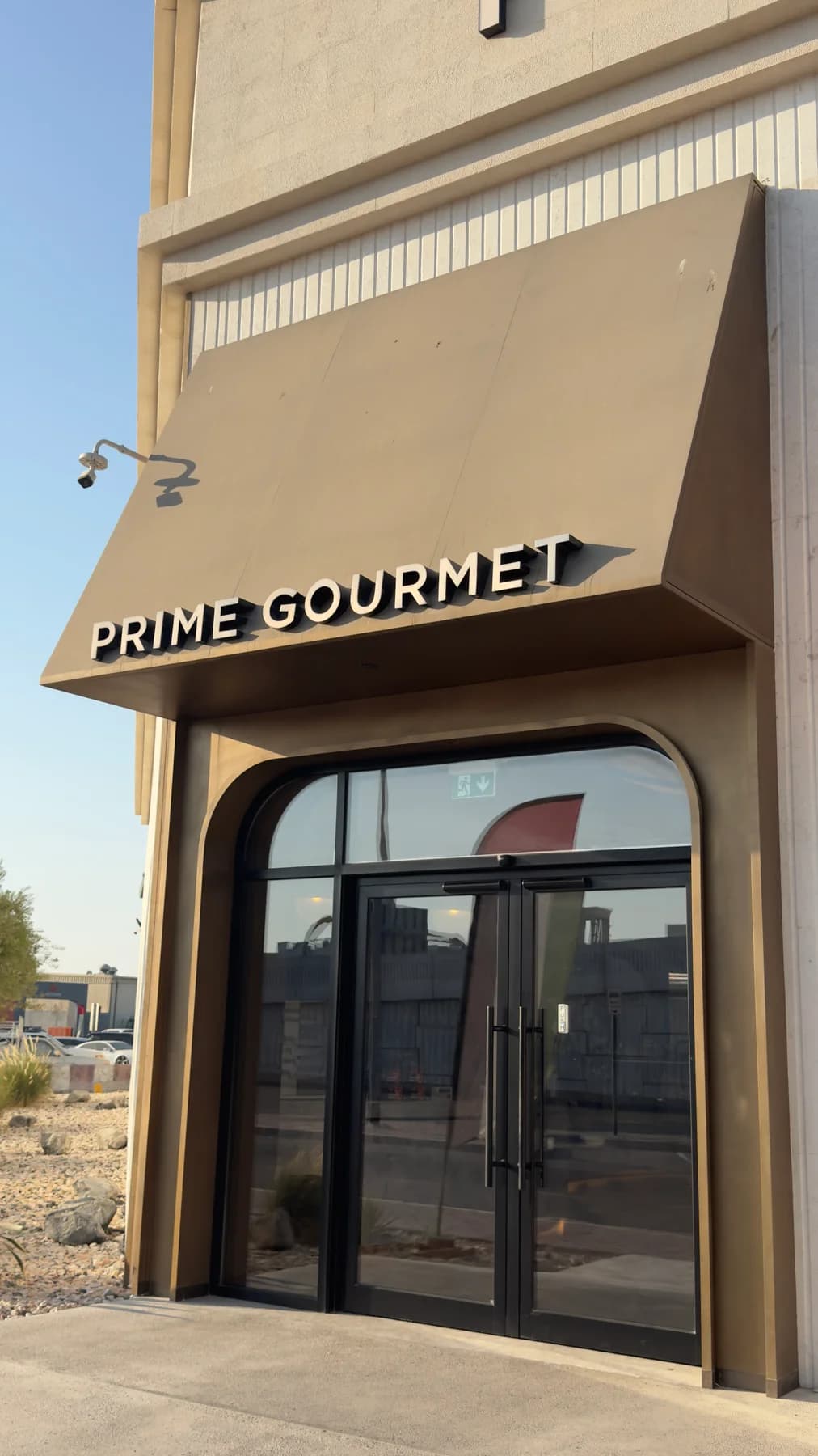 Prime Gourmet entrance with its sign above the door