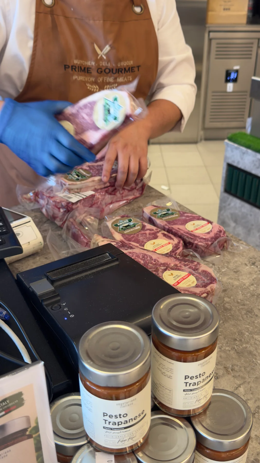 Wrapped marbled steaks on the counter at Prime Gourmet