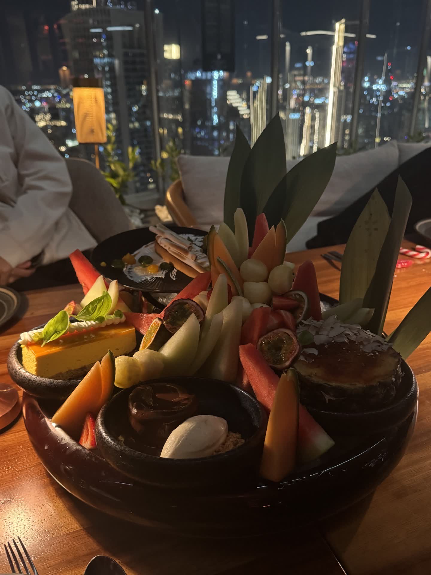 Dinner with the Dubai skyline behind the table.