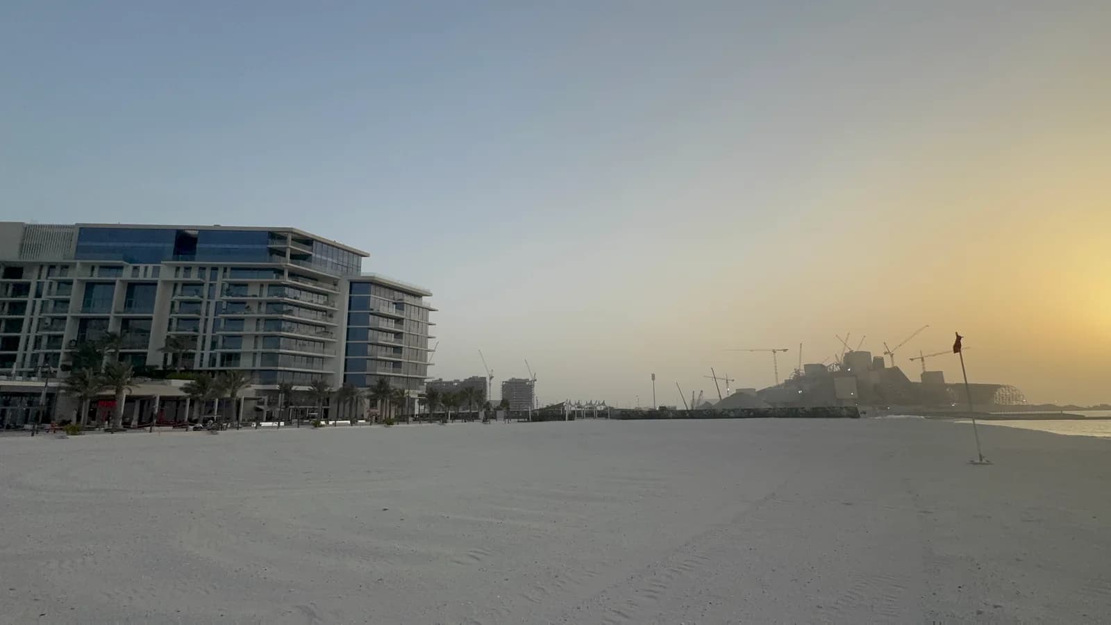 Wide sandy Saadiyat beachfront in evening light
